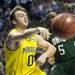 Michigan senior Zack Novak passes the ball under the net in the first half of the second round of the NCAA tournament at Bridgestone Arena in Nashville, Tenn.  Melanie Maxwell I AnnArbor.com